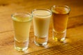 Fresh organic apple cider with apples and cinnamon over rustic wooden background. Close up three glasses Royalty Free Stock Photo