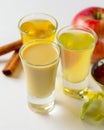 Fresh organic apple cider with apples and cinnamon over white background. Close up three glasses Royalty Free Stock Photo