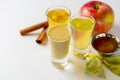Fresh organic apple cider with apples and cinnamon over white background. Close up three glasses Royalty Free Stock Photo