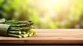 Fresh organic asparagus on wooden table with copy space and blurred kitchen background Royalty Free Stock Photo