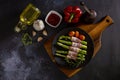 Fresh organic asparagus wrapped in Parma ham on a cutting board top view Royalty Free Stock Photo