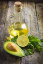 Fresh organic avocado, lime, parsley and olive oil on old wood Royalty Free Stock Photo