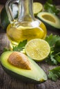 Fresh organic avocado, lime, parsley and olive oil on old wood Royalty Free Stock Photo