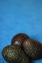 Fresh Organic Avocados on blue background