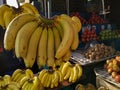 Fresh organic bananas hanging in fruit stall