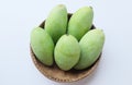 Fresh organic Barracuda mangoes fruit in a beautiful Thai wicker on white background in Thailand. Tropical fruit in thailand.