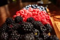 Fresh organic berries - blackberries, raspberries, blueberries on a wooden board Royalty Free Stock Photo