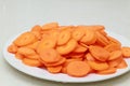 Fresh organic carrot sliced macro background in a white plate