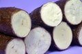 Fresh Organic Cassava Root, Manioc Esculenta, yuca On purple Background Royalty Free Stock Photo