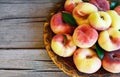 Fresh organic chinese flat peaches with leaves on a copper plate on old wooden rustic table.Saturn donut, Doughnut peach, Paraguay Royalty Free Stock Photo