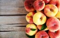 Fresh organic chinese flat peaches with leaves on old wooden background.Saturn donut, Doughnut peach, Paraguayo.Healthy eating or Royalty Free Stock Photo