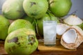 Fresh coconut juice with its meat and a bunch of coconuts. Royalty Free Stock Photo