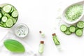 Fresh organic cosmetics with cucumber. Cream, lotion, spa salt on white background top view copyspace