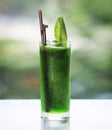 Fresh organic green leafy vegetable detox juice in tall glass