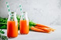 Fresh detox carrot juice in glass bottles on a gray stone background Royalty Free Stock Photo