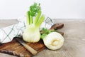 Fresh organic fennel on rustic board with knife