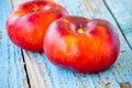 Fresh organic flat nectarines on an old wooden background Royalty Free Stock Photo