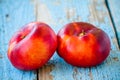 Fresh organic flat nectarines on an old wooden background Royalty Free Stock Photo