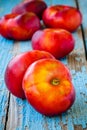 Fresh organic flat nectarines on an old wooden background Royalty Free Stock Photo