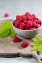 Fresh organic fruit - ripe raspberry with leaves on wood background Royalty Free Stock Photo