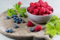 Fresh organic fruit - ripe raspberry with leaves on wood background Royalty Free Stock Photo