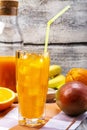 Fresh organic fruits cocktail on colorful background, fresh, tasty and healthy fruits cocktail. Orange cocktail juice with banana, Royalty Free Stock Photo
