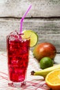 Fresh organic fruits cocktail on colorful background, fresh, tasty and healthy fruits cocktail. Red cocktail juice with banana, ma Royalty Free Stock Photo