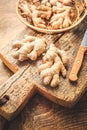 Fresh organic ginger roots on wooden background Royalty Free Stock Photo