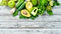 Fresh organic green fruits and vegetables. Avocado, kiwi, onion, lime, parsley. Organic food. Rustic style. Royalty Free Stock Photo