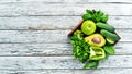 Fresh organic green fruits and vegetables. Avocado, kiwi, onion, lime, parsley. Organic food. Rustic style. Royalty Free Stock Photo