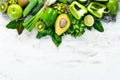 Fresh organic green fruits and vegetables. Avocado, kiwi, onion, lime, parsley. Organic food. Rustic style. Royalty Free Stock Photo