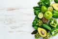 Fresh organic green fruits and vegetables. Avocado, kiwi, onion, lime, parsley. Organic food. Rustic style. Royalty Free Stock Photo