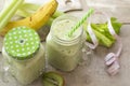 Fresh organic green smoothie with bananas, celery, kiwi. Green detox organic coctail concept. Spring card, tape measure Royalty Free Stock Photo