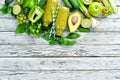 Fresh organic green smoothie on a wooden background. Fresh Green Fruits and Vegetables. Organic food. Rustic style. Royalty Free Stock Photo