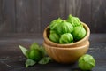 Fresh organic green tomatillos Physalis philadelphica with a husk on rustic wooden table.