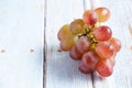 Fresh organic group of sweet juicy and healthy grapes fruit on white wooden board background Royalty Free Stock Photo