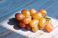 Fresh organic group of sweet juicy and healthy grapes fruit on white wooden board background with sunshine Royalty Free Stock Photo