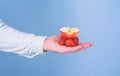 Fresh organic harvest of ripe fruit berries. Male hand with strawberries and half of apple blue background. Hand Royalty Free Stock Photo