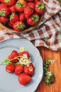 Fresh organic home growth strawberries on wooden table in plate Royalty Free Stock Photo