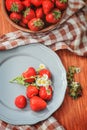 Fresh organic home growth strawberries on wooden table in plate Royalty Free Stock Photo