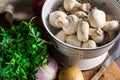 Fresh organic ingredients for preparing healthy vegetarian meal potatoes, mushrooms in colander, halved onion, parsley Royalty Free Stock Photo