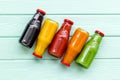 Fresh organic juices in bottles for fitness diet on green wooden background top view mock-up Royalty Free Stock Photo