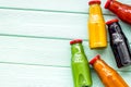 Fresh organic juices in bottles for fitness diet on green wooden background top view mock-up Royalty Free Stock Photo