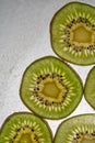 Fresh organic kiwi fruit sliced. Food frame with copy space for your text. Green kiwi circles background Royalty Free Stock Photo