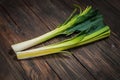 Fresh organic leeks tied on an old wooden board Royalty Free Stock Photo