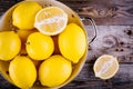 Fresh organic lemons in a colander on a wooden background. Top view Royalty Free Stock Photo