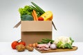 Fresh organic local farm food - group of vegetables eggs and meat in cardboard box