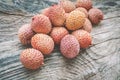 Fresh organic lychee fruit in a bowl on a rustic wooden background. Healthy vegan food concept. Close-up Royalty Free Stock Photo