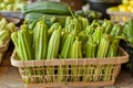 Fresh Organic Okra Displayed in a Rustic Basket at a Local Farmers Market with Vegetables in Background Royalty Free Stock Photo