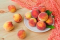 Fresh organic peaches in a plate on a wooden table Royalty Free Stock Photo